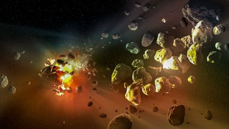 an explosion in space sends a rocky asteroid breaking apart into smaller chunks of rock