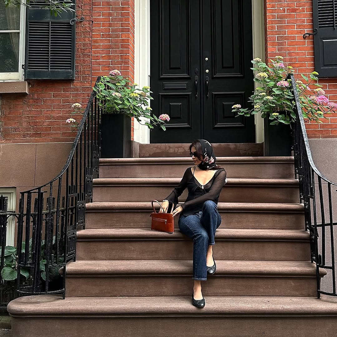 Woman wearing dark wash bootcut jeans fall 2025.