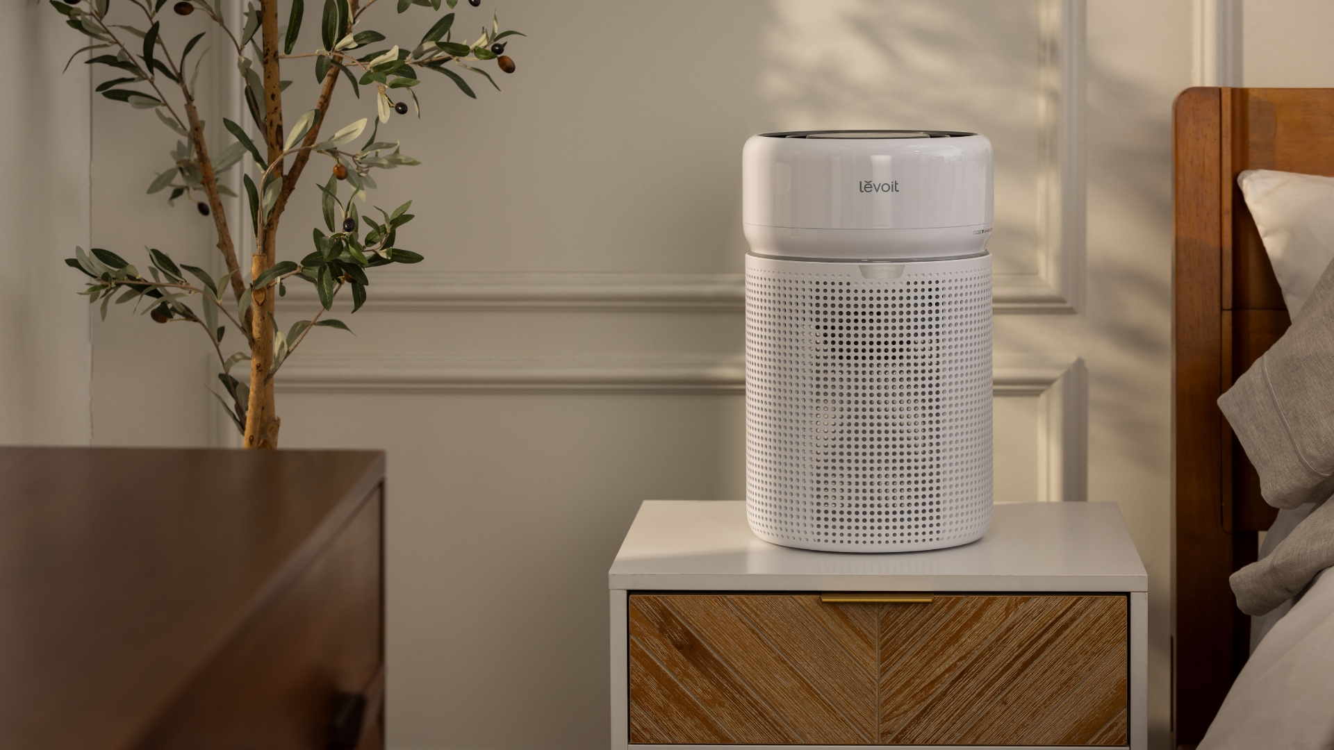 Levoit air purifier on a bedside table