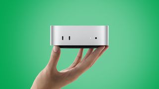 The Apple Mac mini held aloft. 