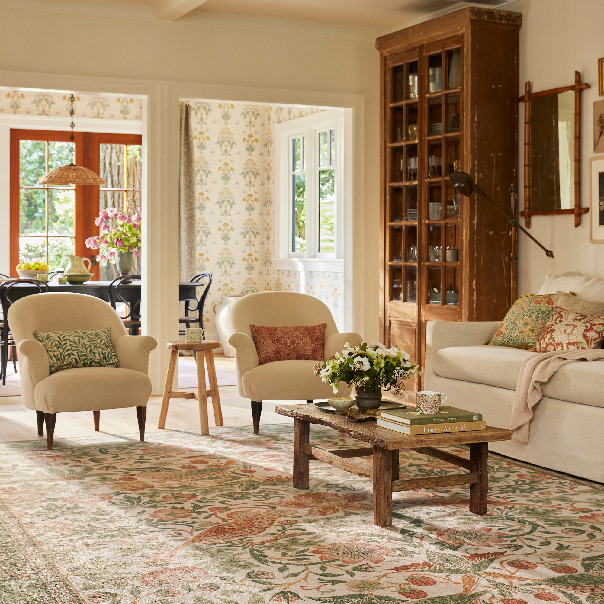 Living room with armchairs, sofa and coffee table on large rug