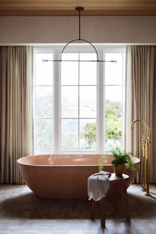 A statement bath with gold taps