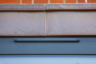 A close up of a trickle vent above glazed doors