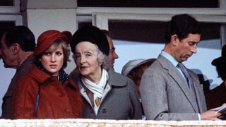 CHELTENHAM, UNITED KINGDOM - APRIL 03: Diana, Princess Of Wales, Talking To Her Grandmother, Ruth, Lady Fermoy During The National Hunt Festival At Cheltenham. Prince Charles Is Beside Them Reading A Racing Programme.