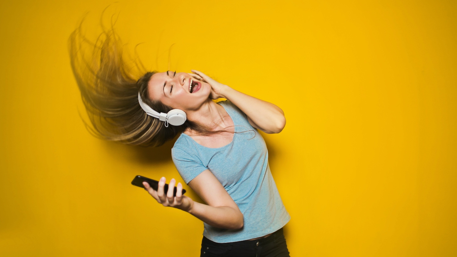 How to relax on Mother's Day: a woman listens to music on headphones