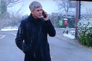 Caleb on the phone in the snow