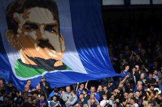 Everton fans wave a banner featuring an image of their former goalkeeper Neville Southall in 2018.