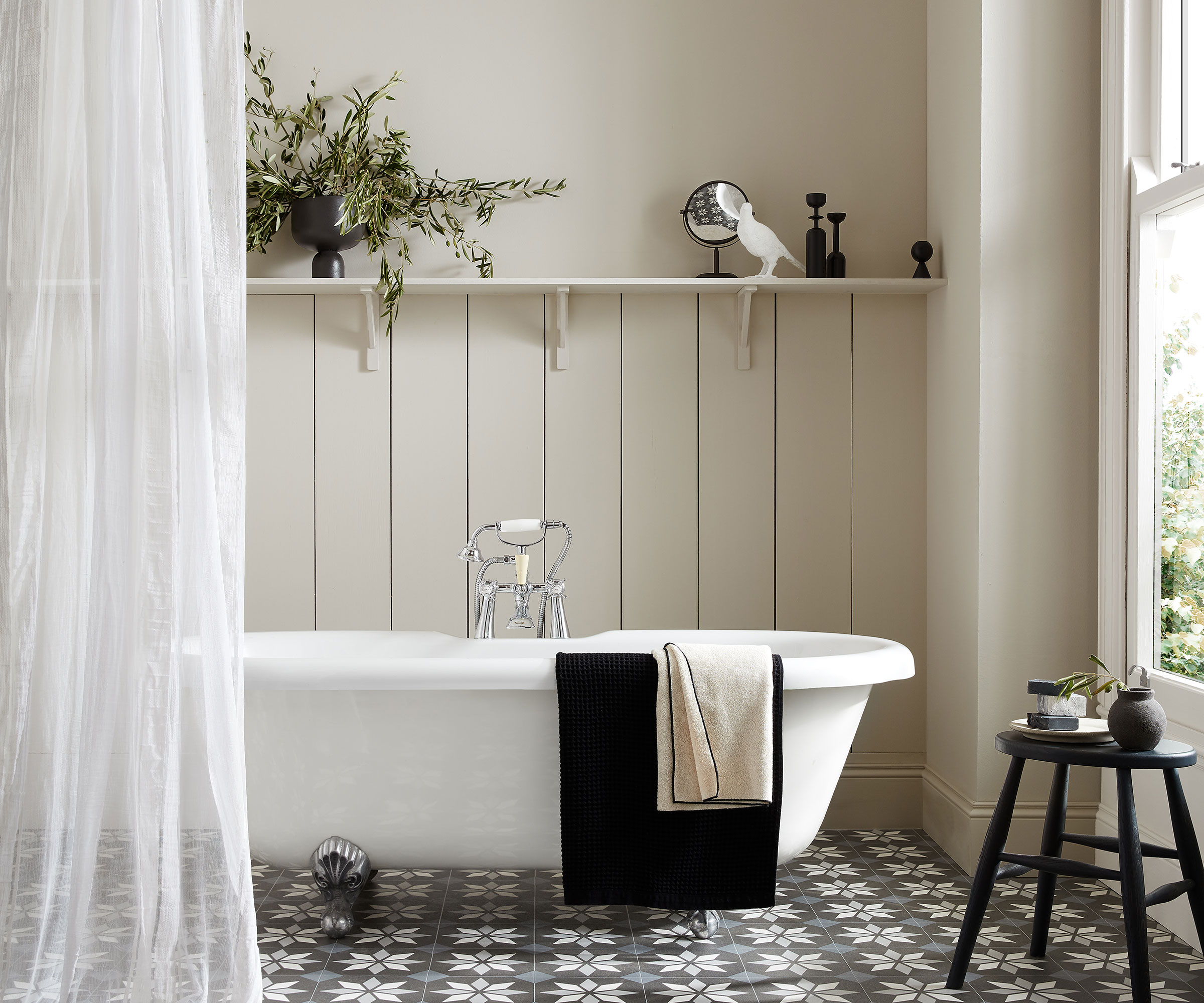 bathroom with off-white walls and patterned floor tiles