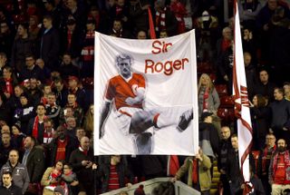 Liverpool fans hold up a banner for former player Roger Hunt