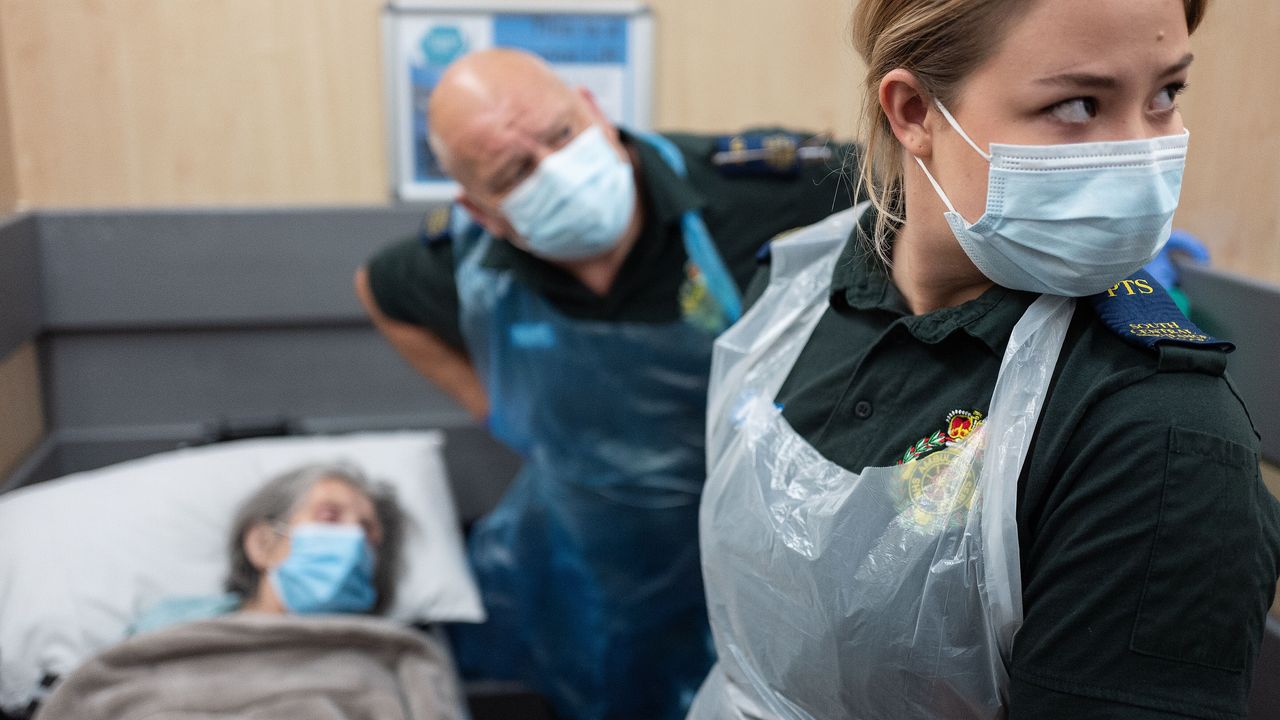 South Central Ambulance Services move an elderly patient from hospital to a care home.