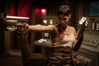 Sofia Boutella aims a gun, in a still from 'rebel moon part 2 the scargiver'