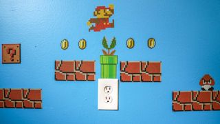 A closeup of the Mario decals showing a warp pipe coming out of an AC outlet
