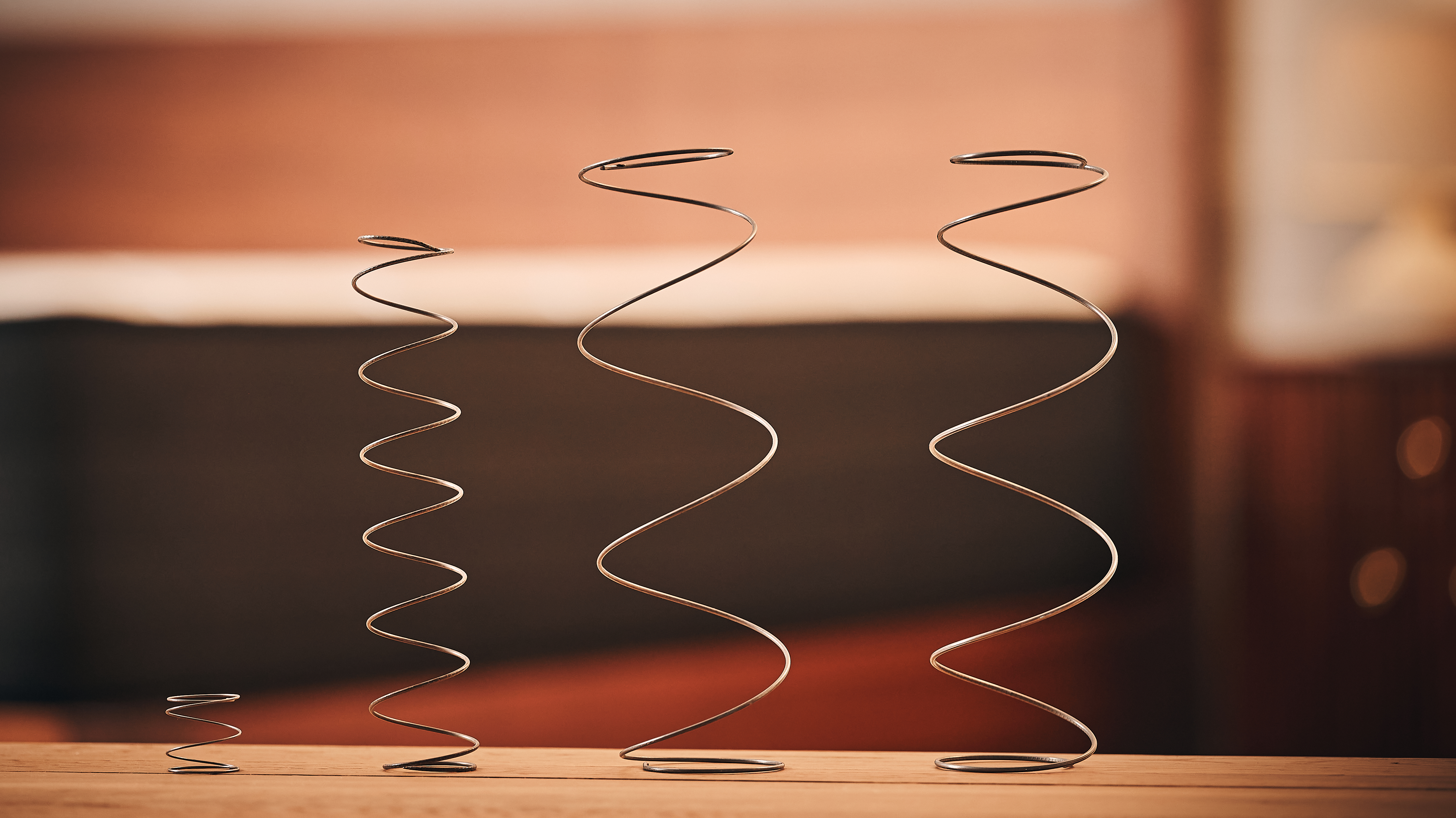 Four different types and sizes of mattress coils placed in a straight line