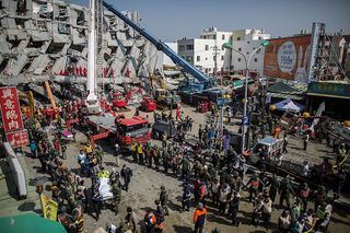 Rescue workers transport a body near the collapsed Weiguan Golden Dragon high-rise tower in Tainan, Taiwan, on Feb. 7, 2016