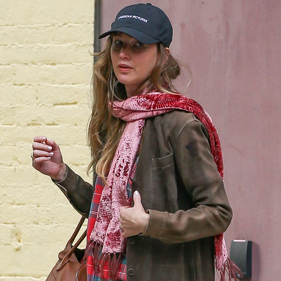Jennifer Lawrence styled a brown suede coat with The Row Margaux Bag and white Dior sneakers