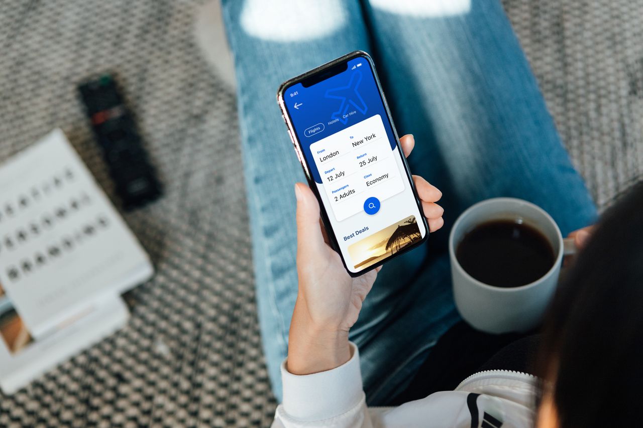 a woman browsing flights on her smartphone, using an unspecified travel app