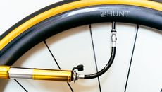 A bike pump attached to a carbon fibre hunt wheel 