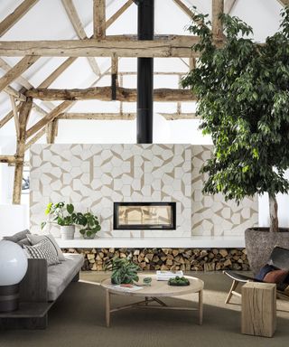 Hexagon Split Shift Bert & May tiles above fireplace with log storage, wooden furniture and tree