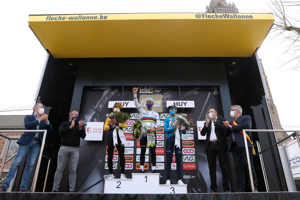 MUR DE HUY BELGIUM APRIL 21 Podium Primoz Roglic of Slovenia and Team Jumbo Visma in 2nd place Julian Alaphilippe of France and Team Deceuninck QuickStep in 1st place Alejandro Valverde Belmonte of Spain and Movistar Team in 3rd place celebrates during the 85th La Fleche Wallonne 2021 Men Elite a 1936km race from Charleroi to Mur de Huy 204m Mask Covid safety measures Flowers Medals FlecheWallonne on April 21 2021 in Mur de Huy Belgium Photo by Bas CzerwinskiGetty Images