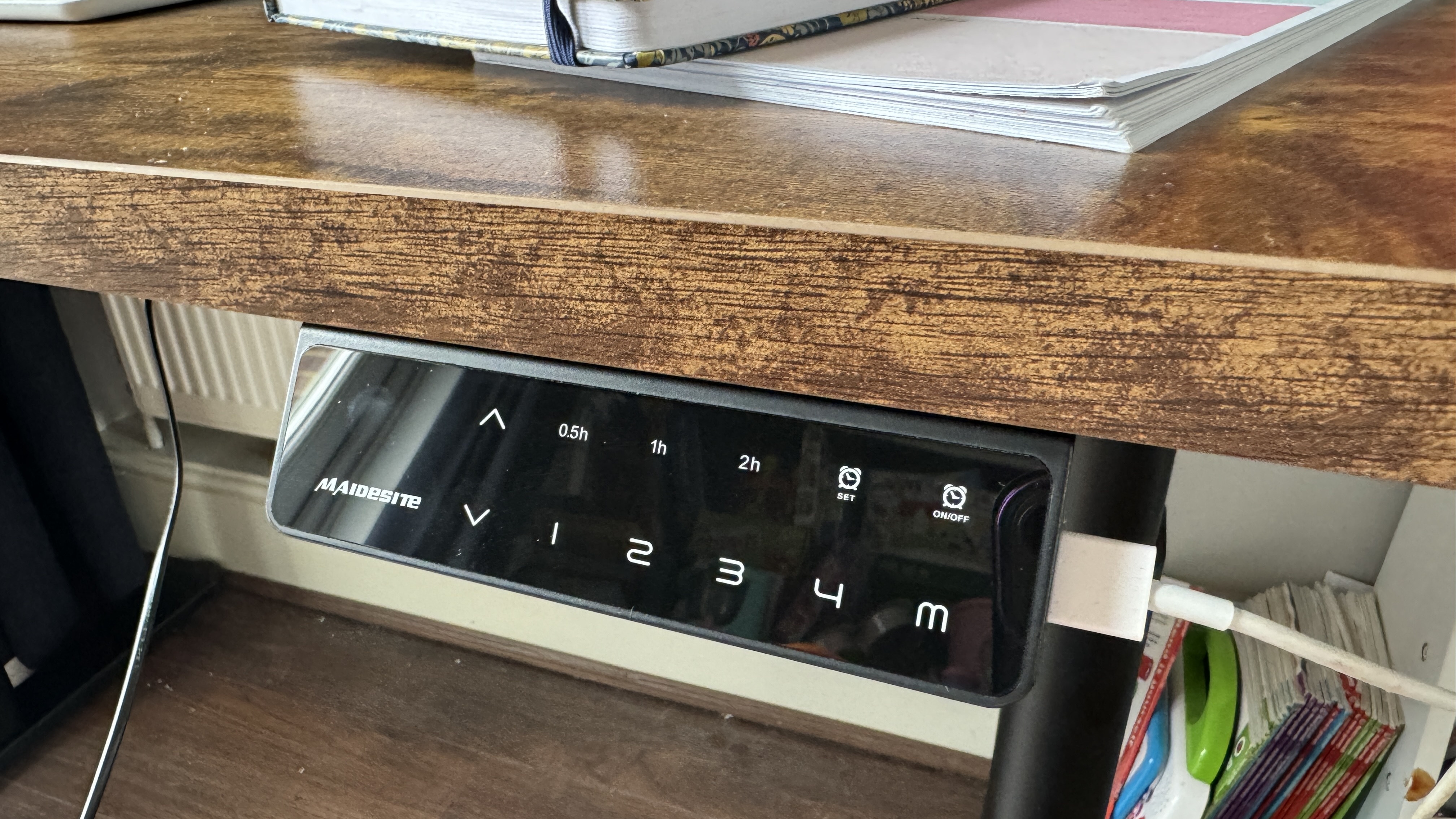 A brown Maidesite TH2 Pro Plus wooden desk in a bright home office