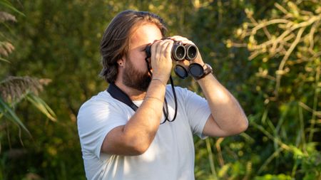 Jase Parnell Brookes using a pair of binoculars