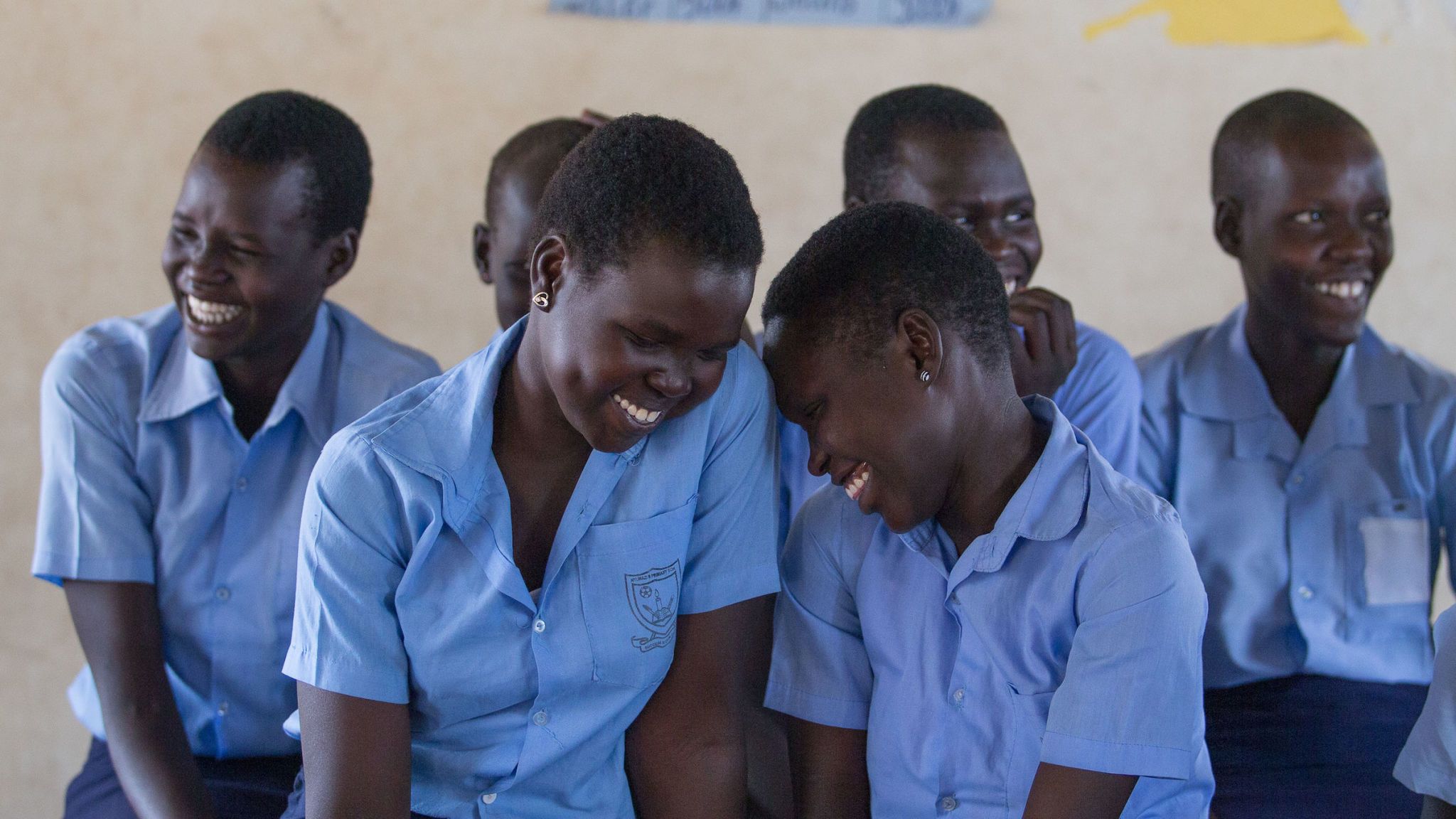 Smile, People, Sleeve, Social group, Community, Collar, Adaptation, Team, Uniform, Sharing,