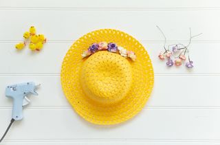 Add large paper flowers to the brim of the hat