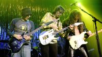 From left, Joe Satriani, Steve Vai, and Yngvie Malmsteen perform, Chicago, Illinois, October 24, 2003