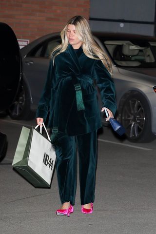 Sofia Richie Grainge wears a jewel tone velvet suit and pink flats while attending a dinner in Los Angeles