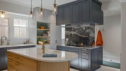 kitchen with oak island, and blue cupboards