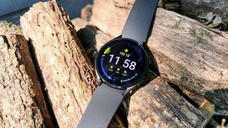 Samsung Galaxy Watch 4 on logs of wood