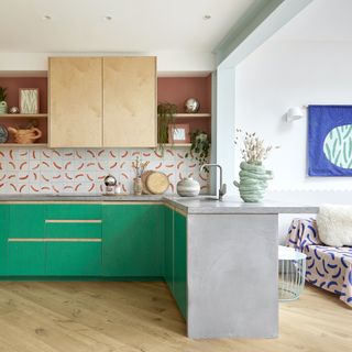 Emerald green and ply kitchen with concrete worktops