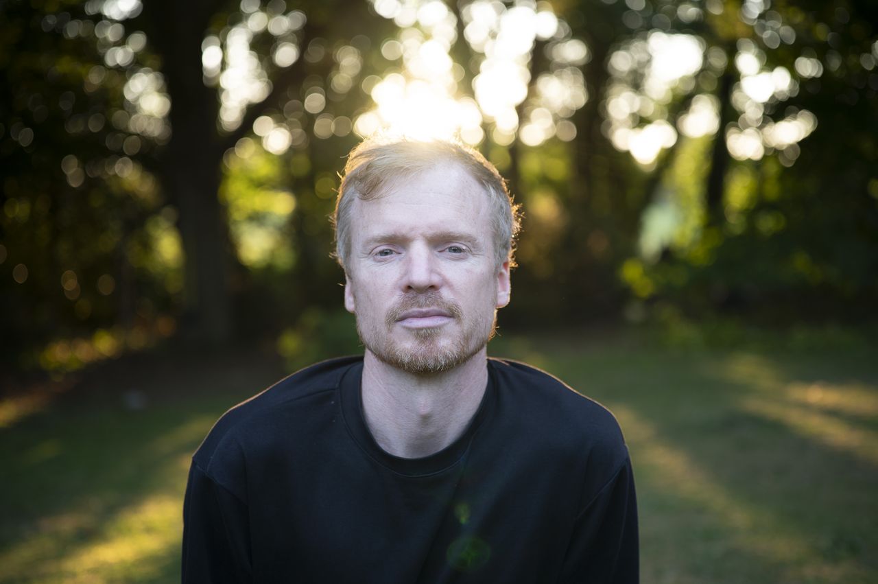 Portrait of a man during golden hour with dappled light through trees, taken with the Viltrox AF 50mm F2 Air lens