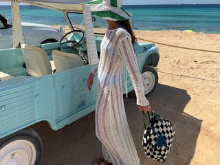 woman in crochet dress at the beach