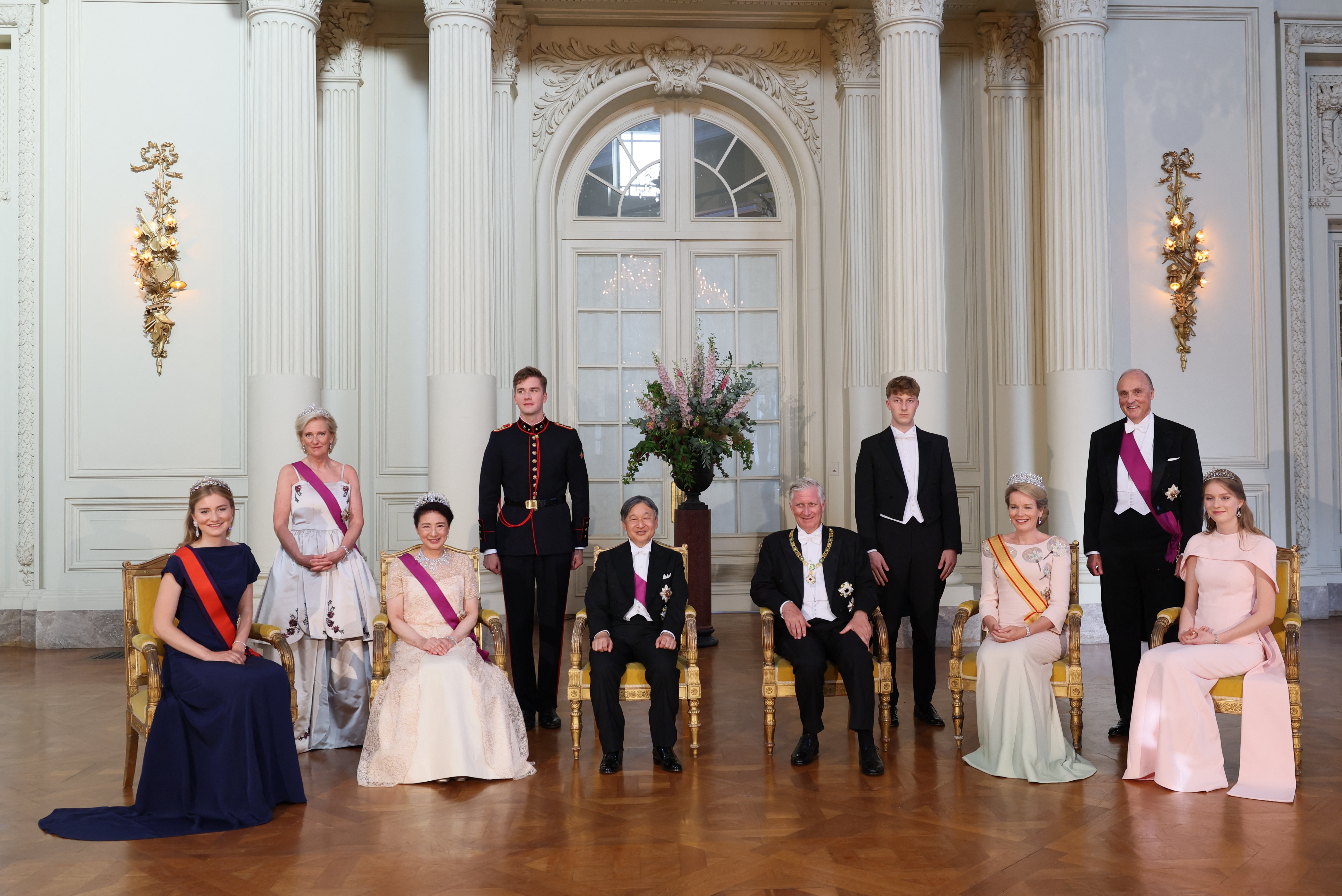 The Belgian royal family posing in tiaras and gowns at a Japanese state banquet