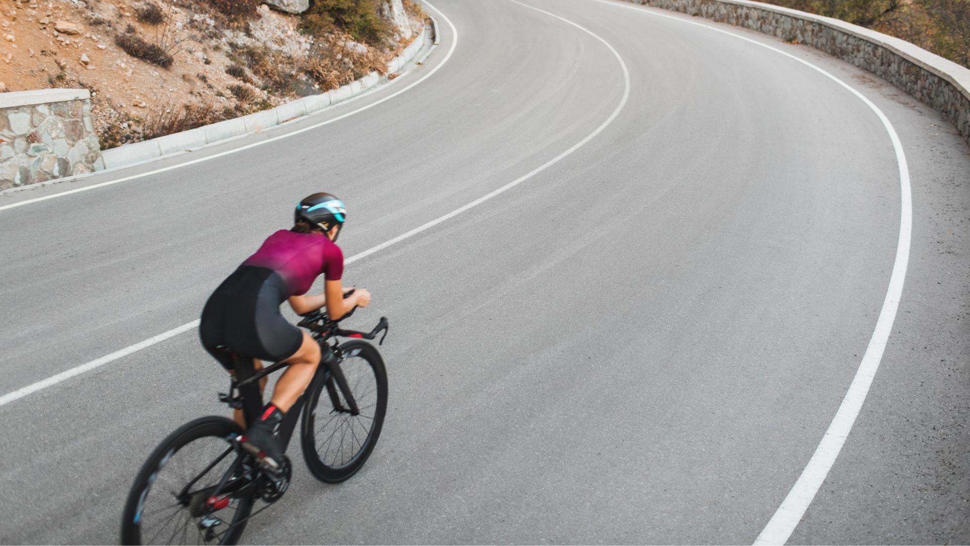 Woman cycling down busy road