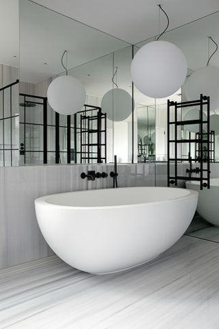 A bathtub with a lighting piece above it