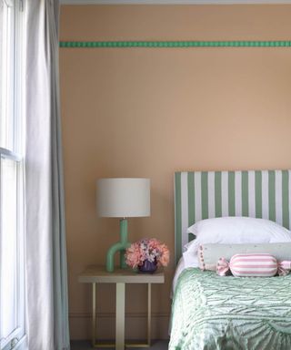 calming bedroom with pastel pink walls and light green accents