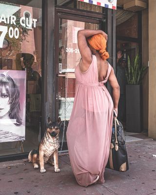 Photography by Anastasia Samoylova, Barber Shop, Miami, 2018, of woman and a dog in front of a barber shop