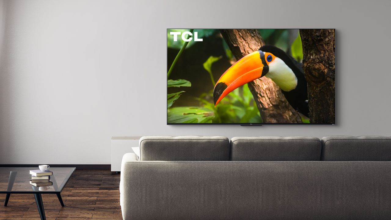 The 2022 TCL R655 hanging on a wall in a living room.