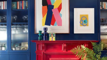 A blue living room with bright red chimney place