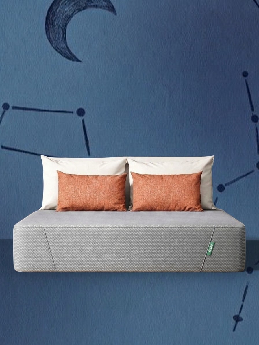 A Siena Memory Foam Mattress with pillows balanced at the head of the bed against a blue background of stars, edited by Gemini
