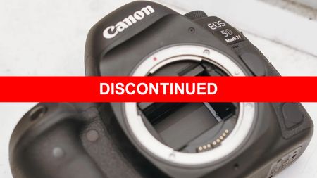 Canon EOS 5D Mark IV camera body shown on a white surface. A bold red banner with white text "DISCONTINUED" is overlaid across the image