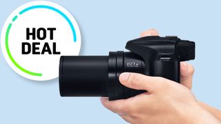 Black camera against blue background.