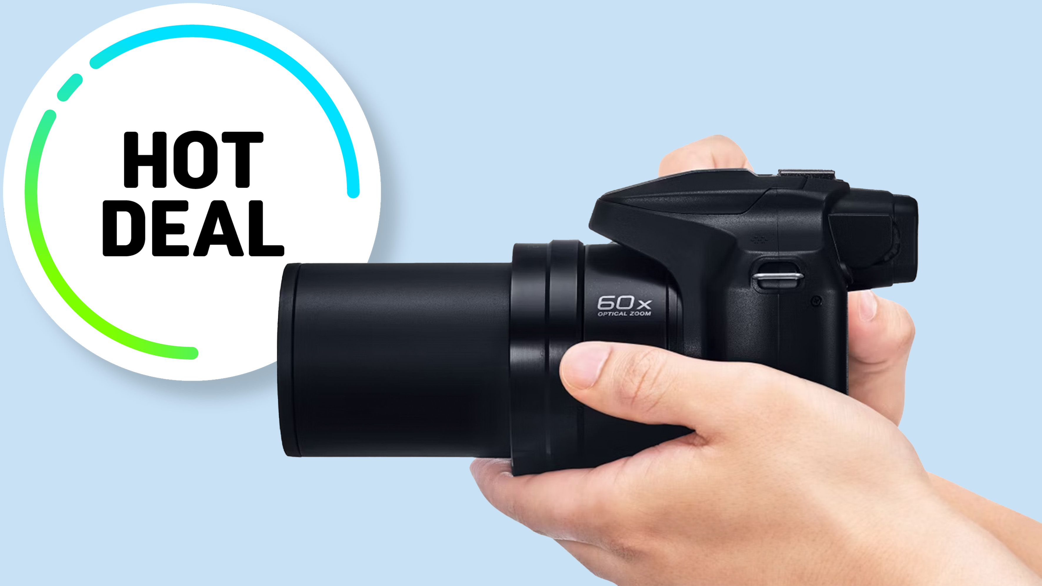 Black camera against blue background. 