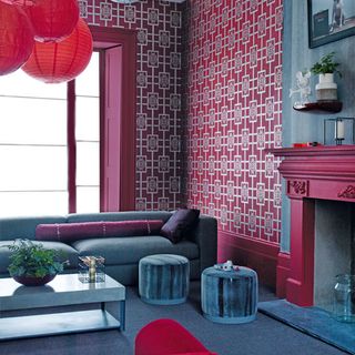 cherry red wall with coffee table and drum stools
