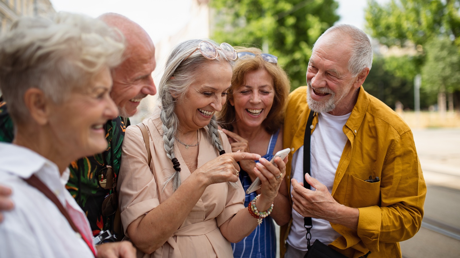 Cheerful men and women travellers looking for direction.
