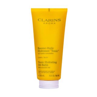 Clarins Tonic-Hydrating Oil Balm in an orange squeeze bottle.