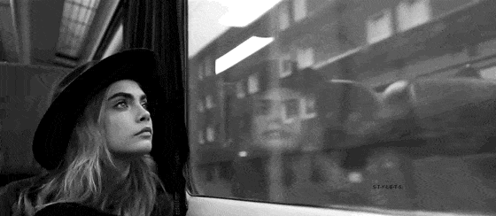 Cara Delevigne looking out a train window