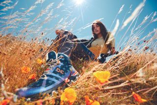 Woman in field with Loewe x On sneakers